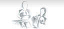 Zierbild: 2 Lehrende sitzen an einem Tisch und tauschen sich aus