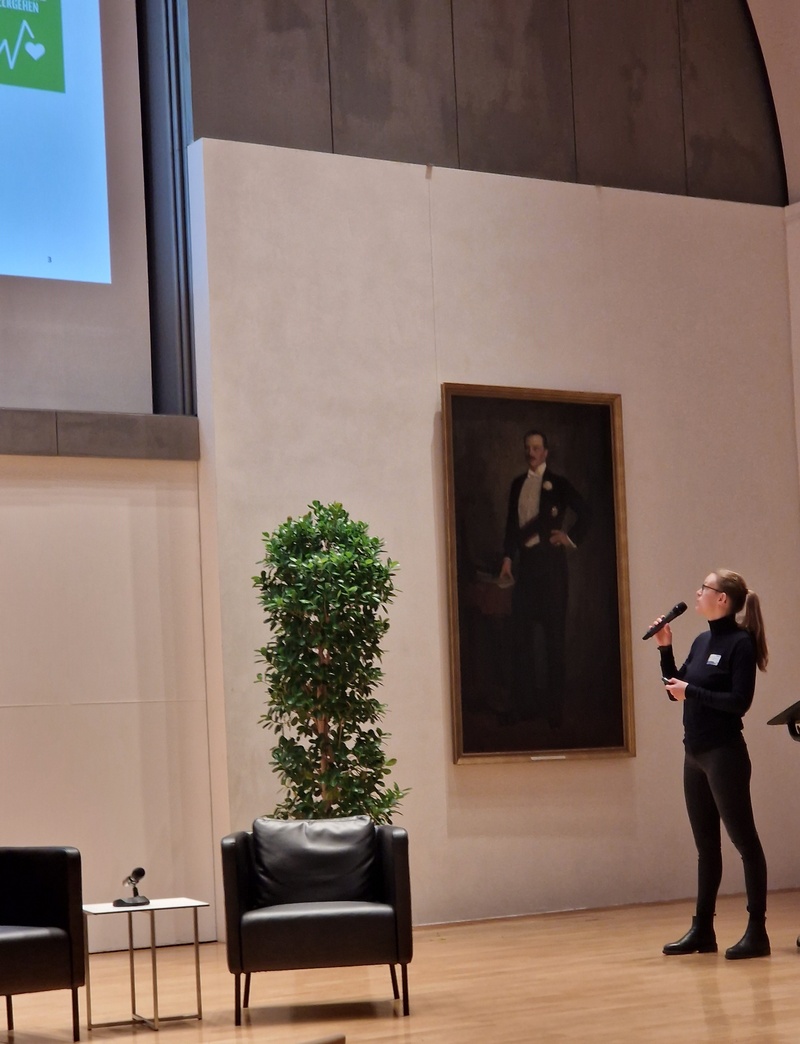 A woman is giving a speech