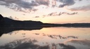 Sky reflected on water surface in evening light