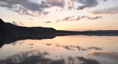 Sky reflected on water surface in evening light