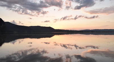 Sky reflected on water surface in evening light