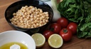 A selection of healthy foods (chickpeas, tomatoes, lemons, salad...)