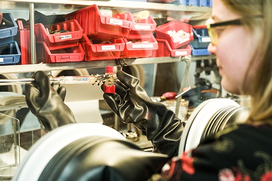 Zentrum für Materialwissenschaft A person wearing protective equipment works in a materials science laboratory.