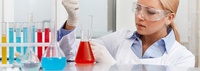 Bild: Frau im Labor, die mit Pipette Flüssigkeit aufnimmt // Photo: Woman in a laboratory taking in liquid with a pipette