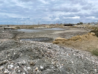 Trocken gefallenes Ufer des Kaspischen Meeres mit exponiertem Seeboden mit Muscheln.