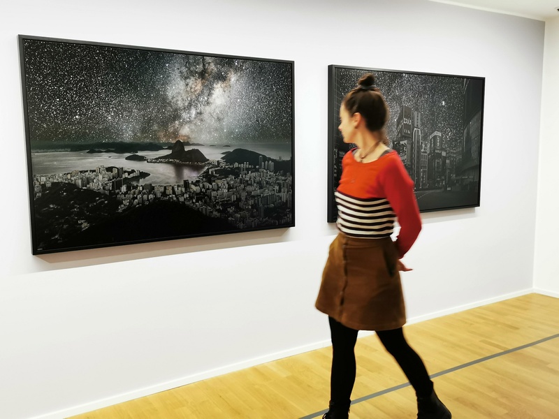 Liza Bauer examining Thierry Cohen’s 'Darkened Cities' - Rio de Janeiro illuminated by natural starlight © Muthuwahandi.jpg