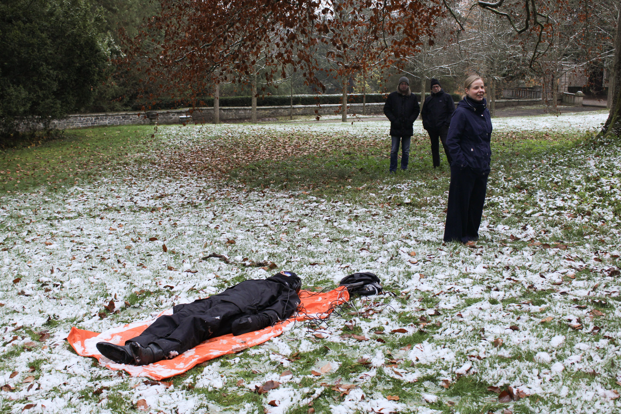 On the castle grounds, Miranda Whall (artist) engages with soil-sensor readings as Milja Kurki (Planetary Agency & Politics Fellow) provides an explanation of the ongoing experiment to participants © Belsoff.jpg