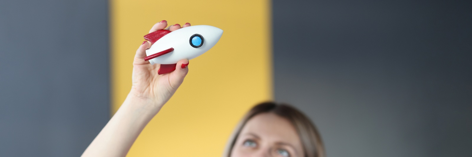 Photo: Woman playing with a toy rocket (colourbox.de)