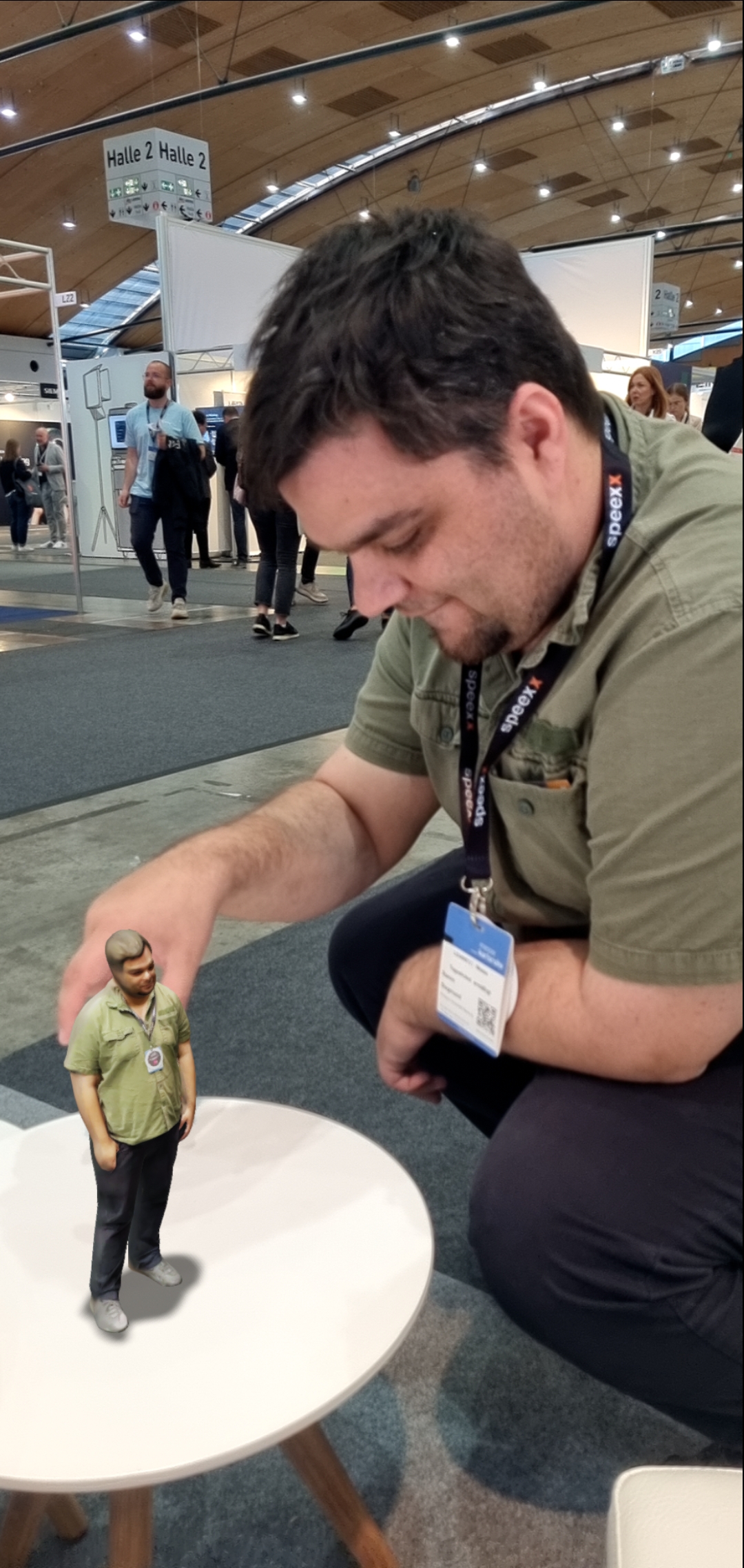 A sitting man, touching his own vr-simulation in front of him